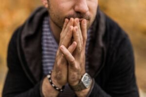 A man resting his hands together while thinking hard. Therapy for anxiety in Portland, OR can help with analysis paralysis. Reach out to get started with an anxiety therapist today.