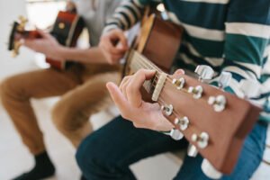 Two individuals playing the guitar near each other. Boost your motivation & improve your mood today with behavioral activation. Learn more tips with anxiety counseling in Portland, OR. 