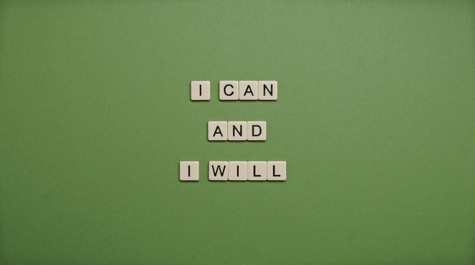 Scrabble letters that read "I CAN AND I WILL" on a green background. Representing how positive affirmations can help you tackle your anxious thoughts. Discover how anxiety counseling in Portland, OR can help your healing journey.