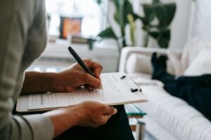 A therapist writing down notes as her client lays on the couch. Discover how trauma counseling in Portland, OR can help you heal from unprocessed trauma. Get the support you deserve today by reaching out.
