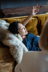 An individual laying down on a fluffy pillow talking to a trauma informed therapist. Discover how our trauma therapists in Portland, OR can help you break free from traumatic memories. Start your healing journey today.