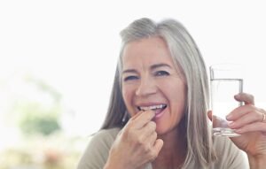 happy woman drinking medicine